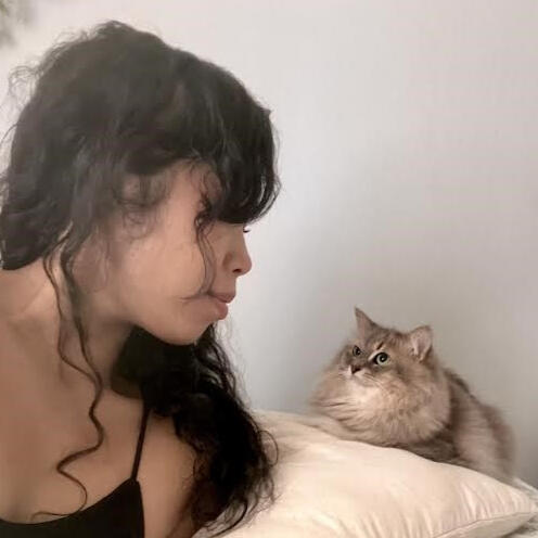 Oanh and her cat, Echo, gazing at each other